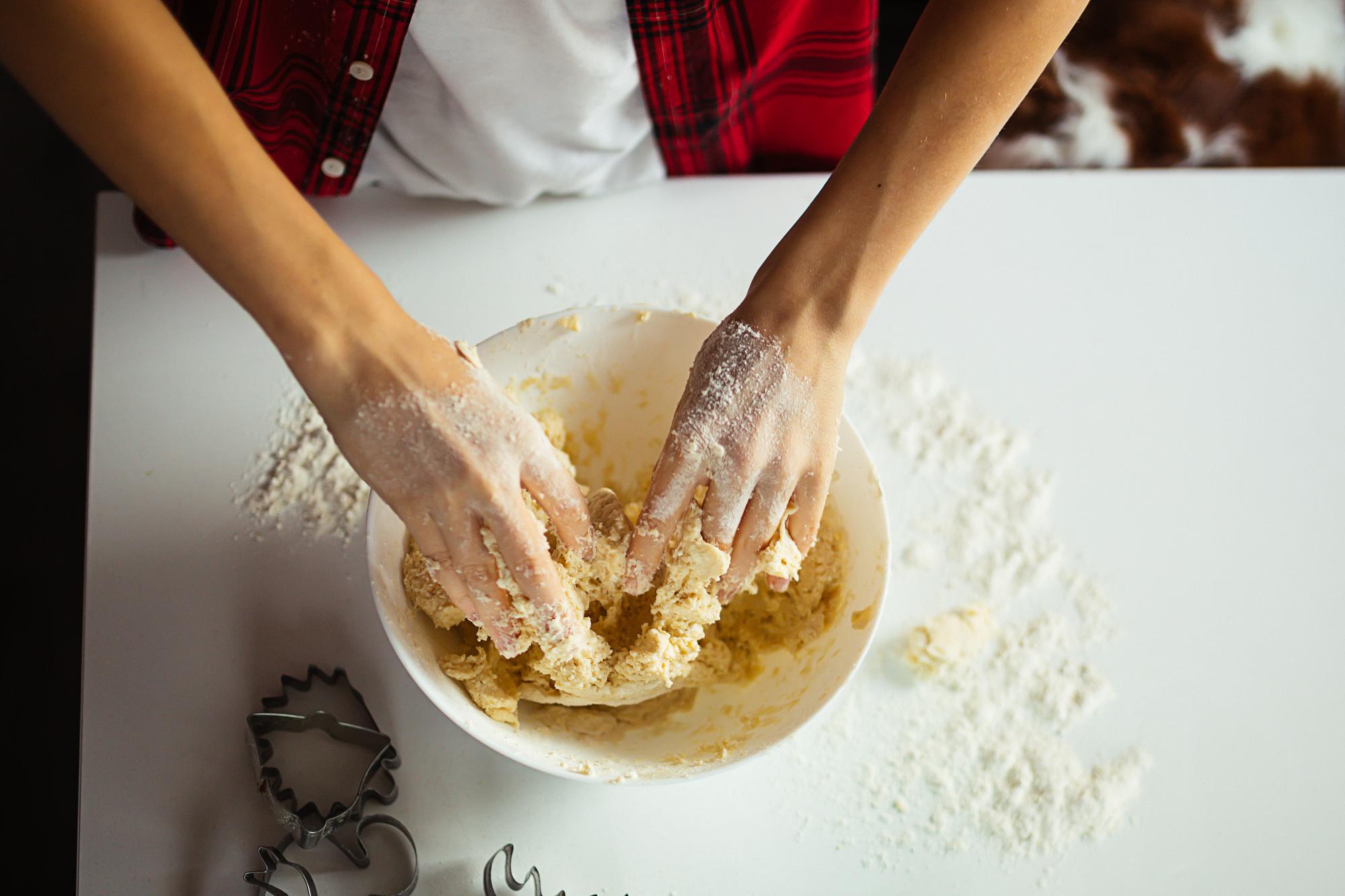Student kneading dough at a workshop